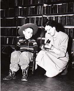 Librarian Frances Carman and little boy in cowboy clothes (1955?)